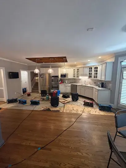 Drying equipment set across an open kitchen and living area in a Cordova home