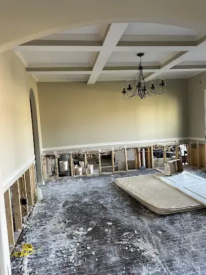 Flood cut drywall and a stripped floor in a Cordova dining room during drying