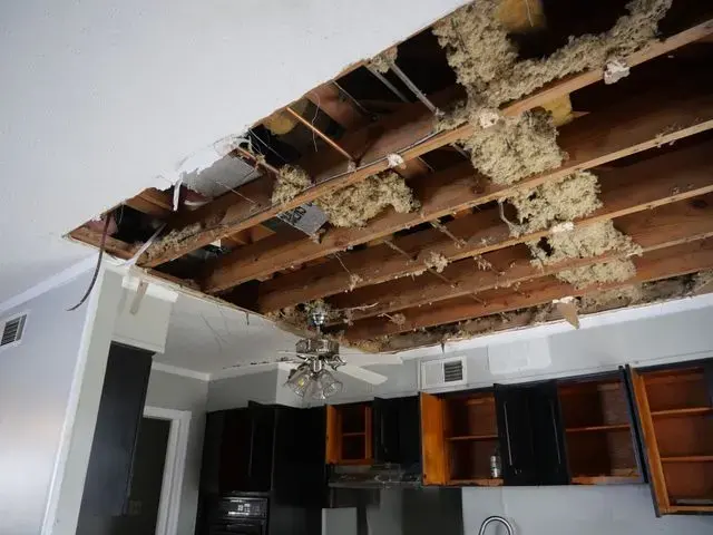Wet ceiling drywall and insulation opened up after a leak in a Cordova kitchen