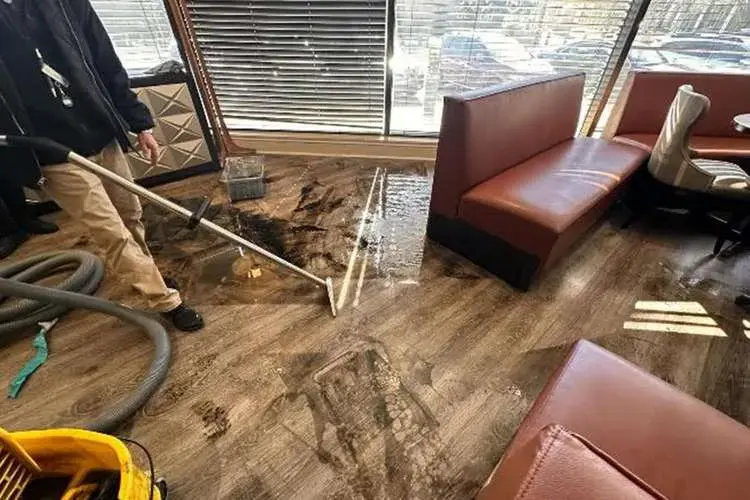Water being pulled from a restaurant floor during a Cordova commercial cleanup