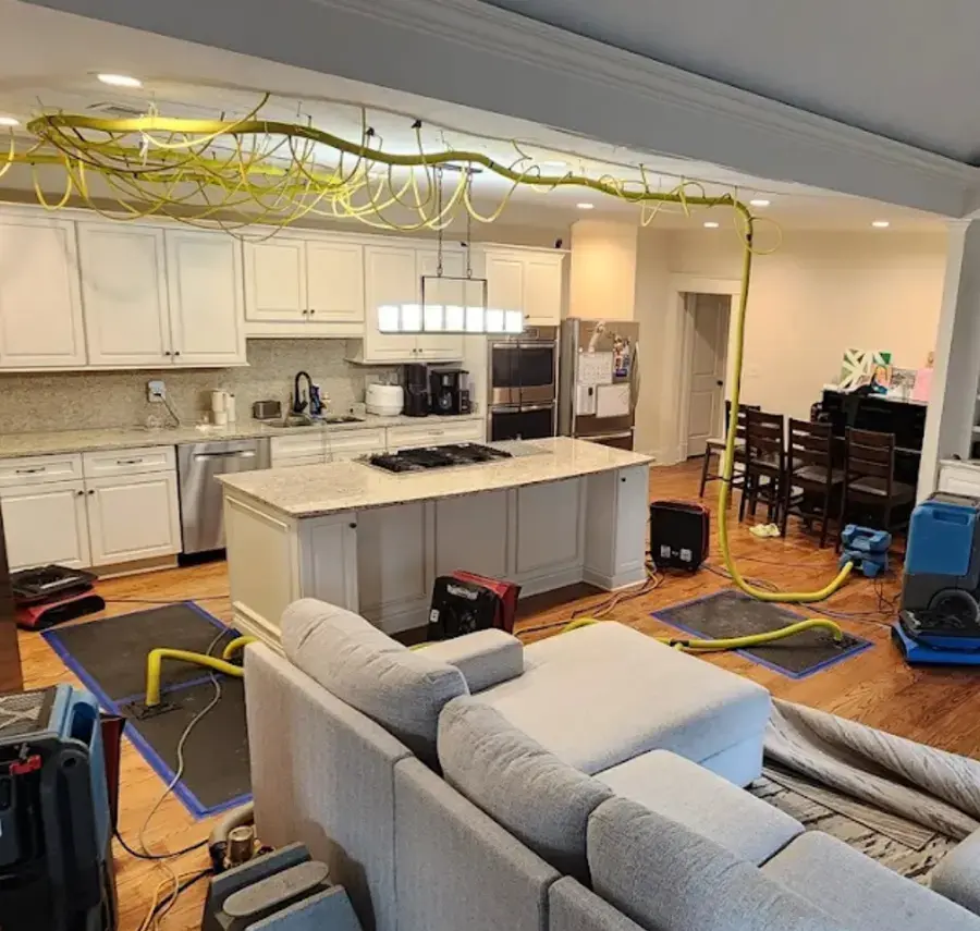 Air movers, dehumidifiers and floor drying mats running in a Cordova home