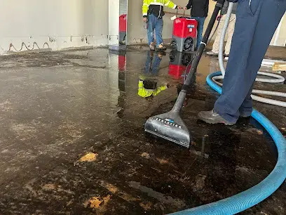 Extraction wand pulling standing water off a floor during a Cordova water removal